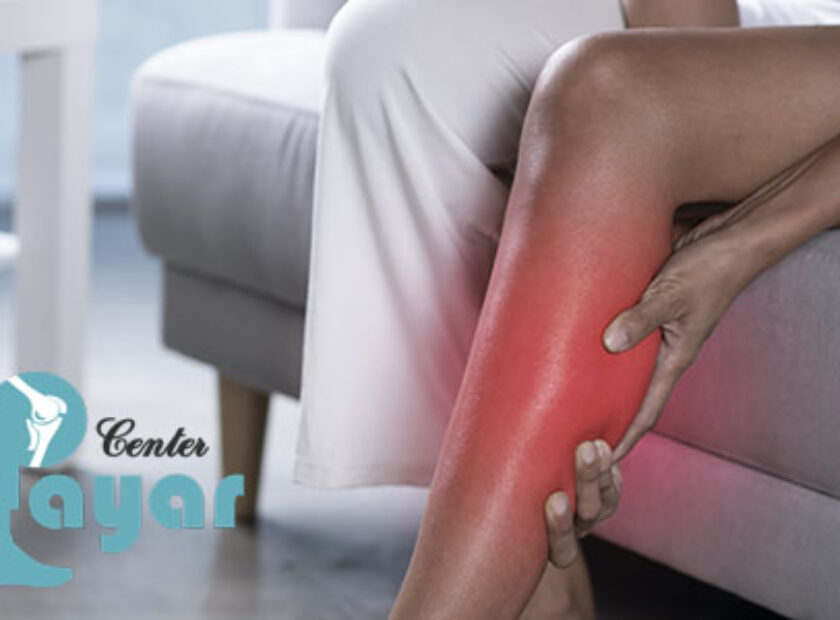 Woman holding the calf with pain.